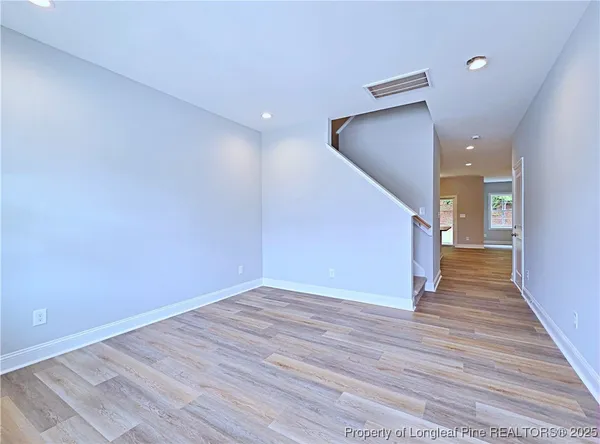 a large kitchen with granite countertop a sink and dishwasher a stove with wooden floor