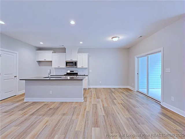 a view of a room with wooden floor and cabinet