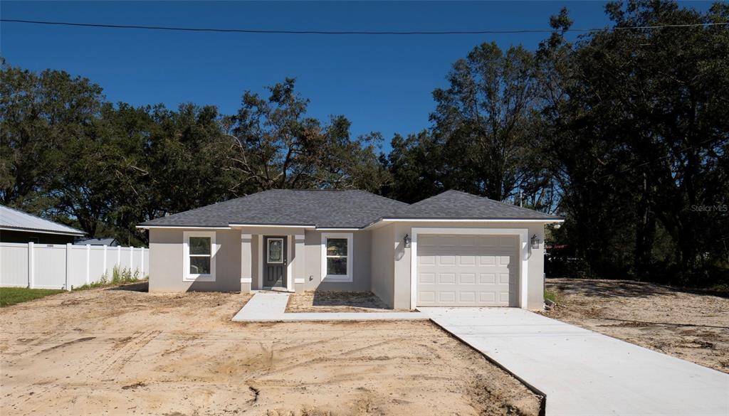 2090 Alderman Road Auburndale, FL 33823 - Photo 1 of 1 a front view of a house with a yard and trees