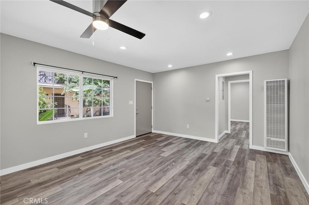 625 East 99th Street Inglewood, CA 90301 - Photo 23 of 50 a view of an empty room with wooden floor and a window