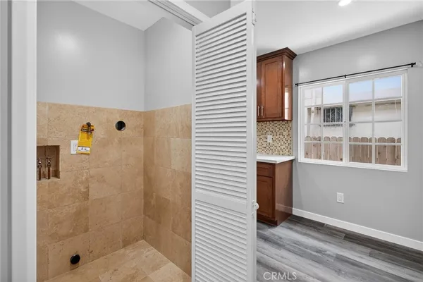 a kitchen with a sink cabinets and a wooden floor