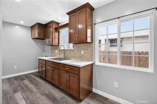 a kitchen with stainless steel appliances granite countertop a sink and a stove