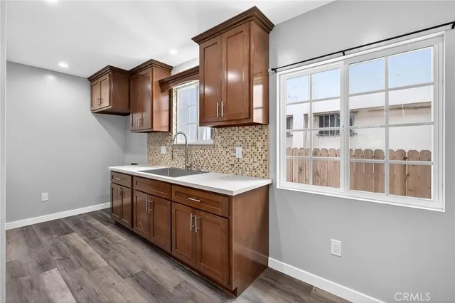 a kitchen with stainless steel appliances granite countertop a sink and a stove