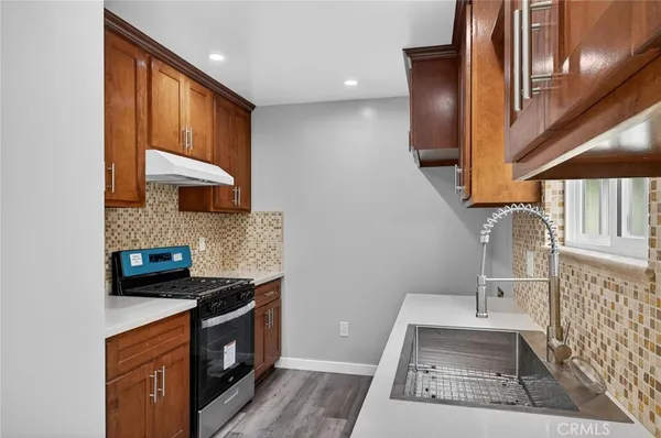 a kitchen with a stove and a sink