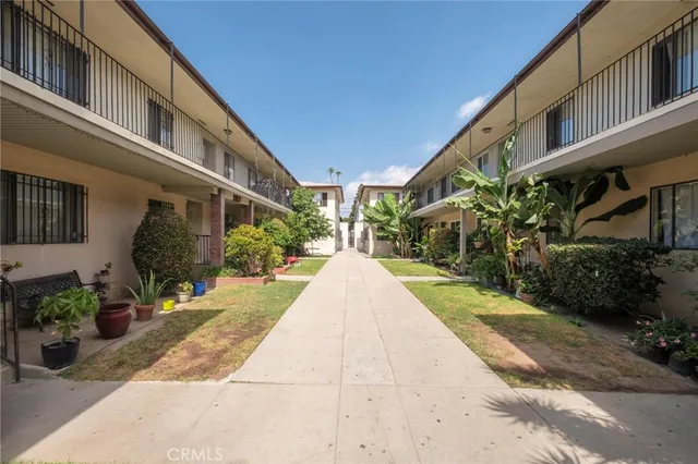 a view of a building with a yard and sitting area