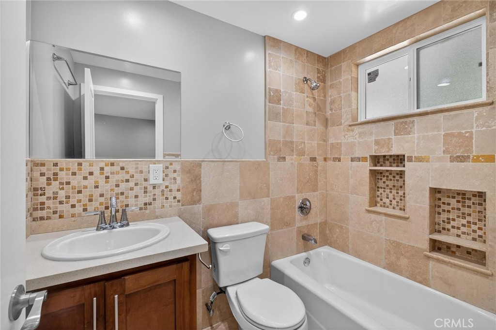 625 East 99th Street Inglewood, CA 90301 - Photo 35 of 50 a bathroom with a sink toilet and shower