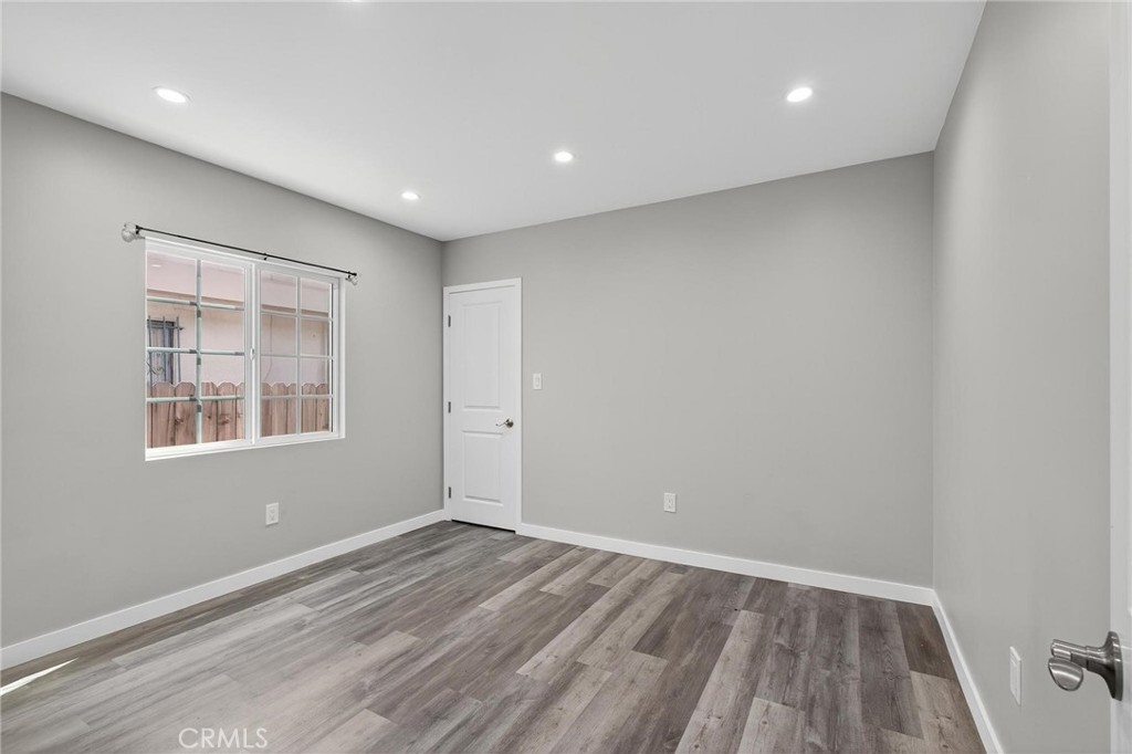 625 East 99th Street Inglewood, CA 90301 - Photo 36 of 50 wooden floor in an empty room with a window