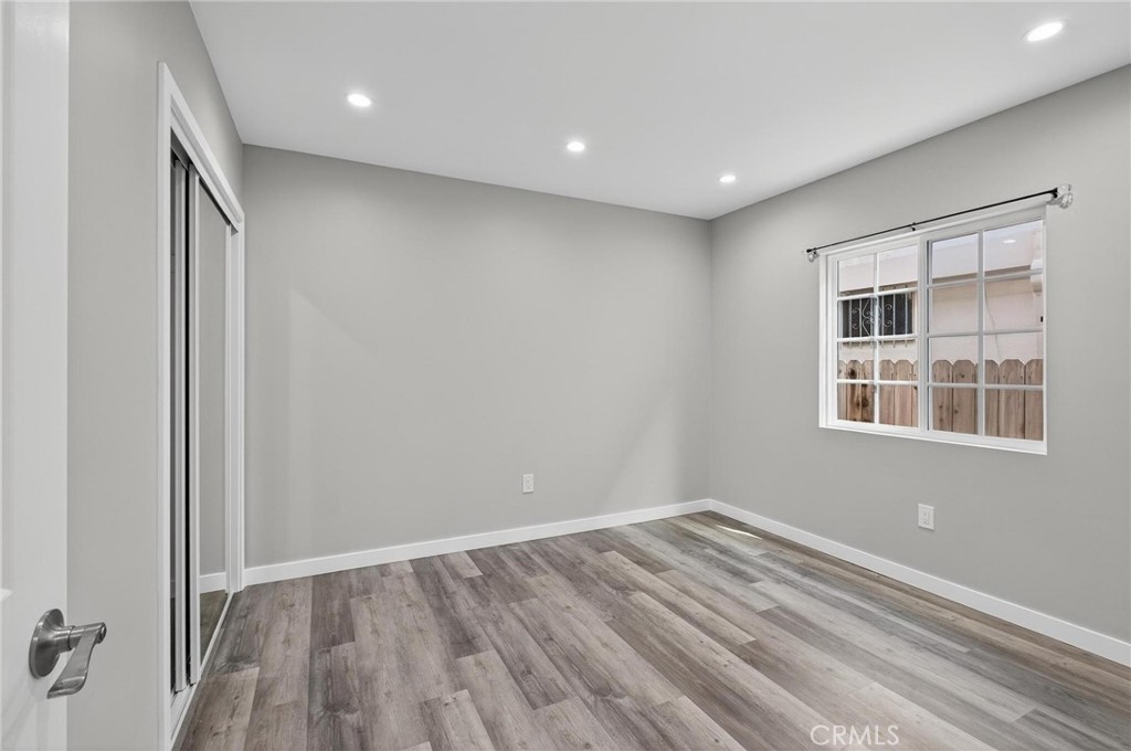 625 East 99th Street Inglewood, CA 90301 - Photo 38 of 50 a view of empty room with wooden floor and fan