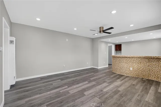 a view of workspace with wooden floor and windows
