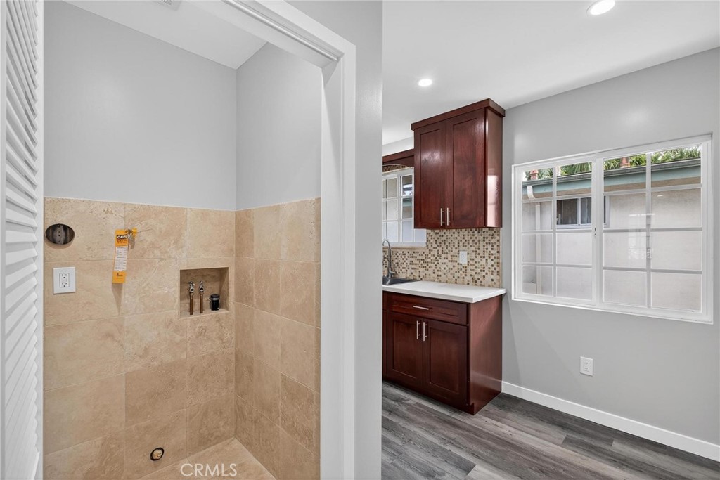 625 East 99th Street Inglewood, CA 90301 - Photo 45 of 50 a bathroom with a granite countertop sink a mirror and shower