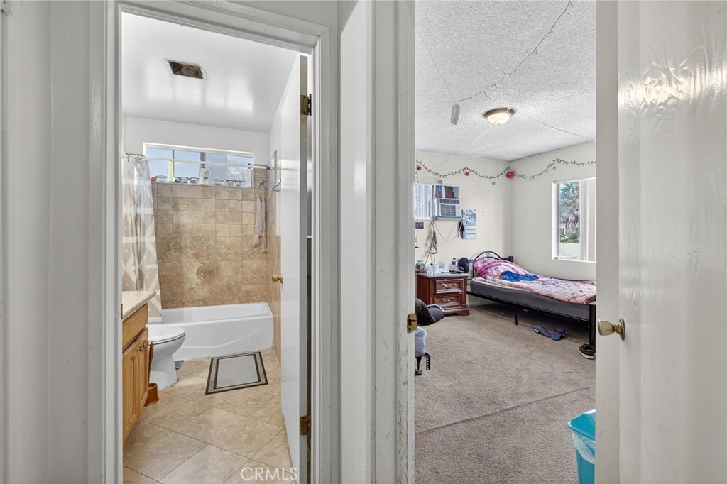 625 East 99th Street Inglewood, CA 90301 - Photo 47 of 50 a view of a bedroom with a bed and glass door