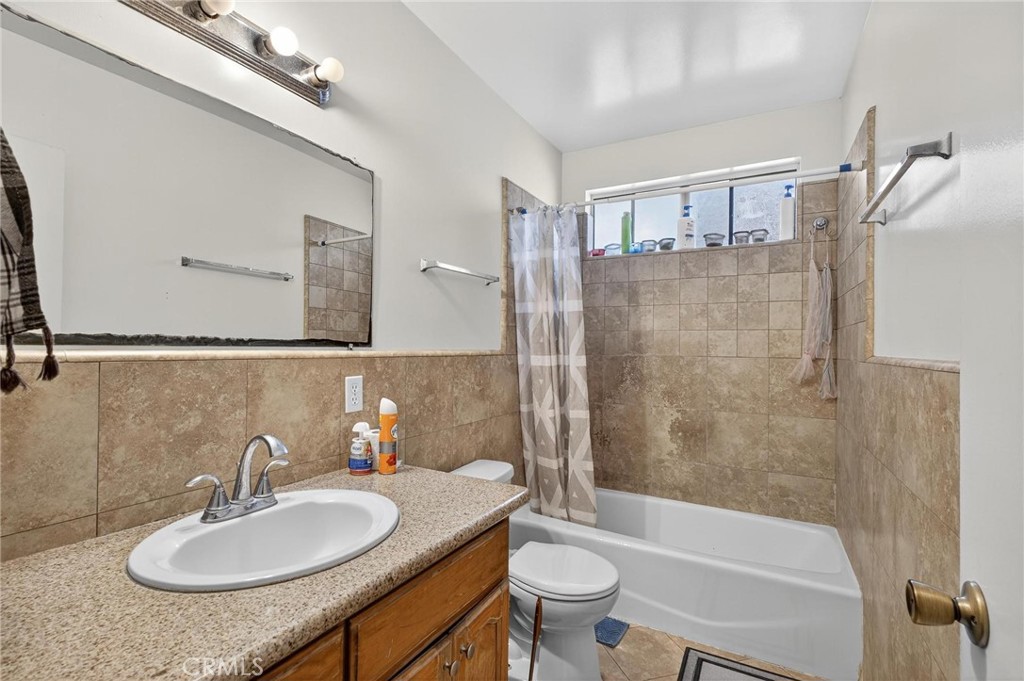 625 East 99th Street Inglewood, CA 90301 - Photo 48 of 50 a bathroom with a sink a toilet and shower