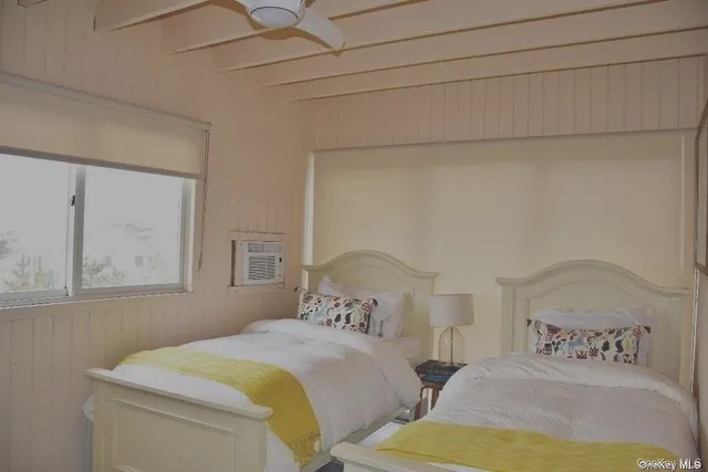 a bedroom with two beds and painted walls