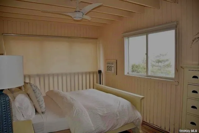 a bed sitting in a bedroom next to a window