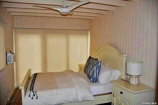 a bedroom with a bed and a mirror