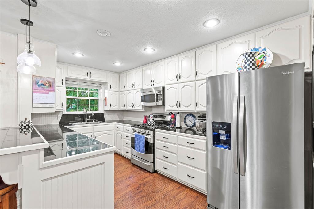 934 North Maple Street Muenster, TX 76252 - Photo 8 of 39 a kitchen with stainless steel appliances granite countertop a refrigerator sink and cabinets