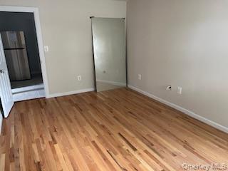 4824 Beverley Road Brooklyn, NY 11203 - Photo 11 of 18 a view of an empty room with wooden floor and a window
