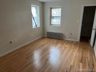 4824 Beverley Road Brooklyn, NY 11203 - Photo 10 of 18 an empty room with wooden floor and windows