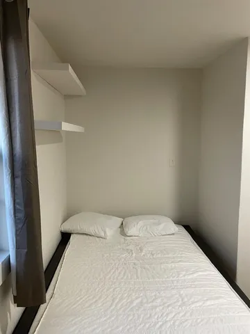 a bedroom with a bed and a mirror