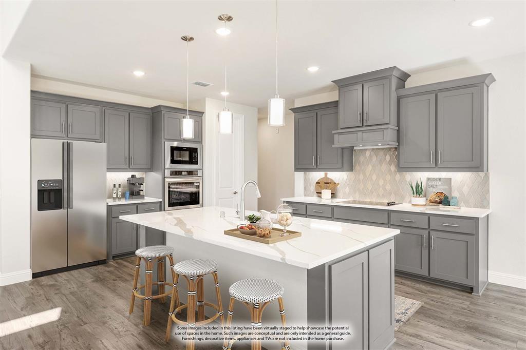 4410 Biscayne Drive Midlothian, TX 76065 - Photo 14 of 40 a kitchen with a sink a stove a refrigerator and white cabinets