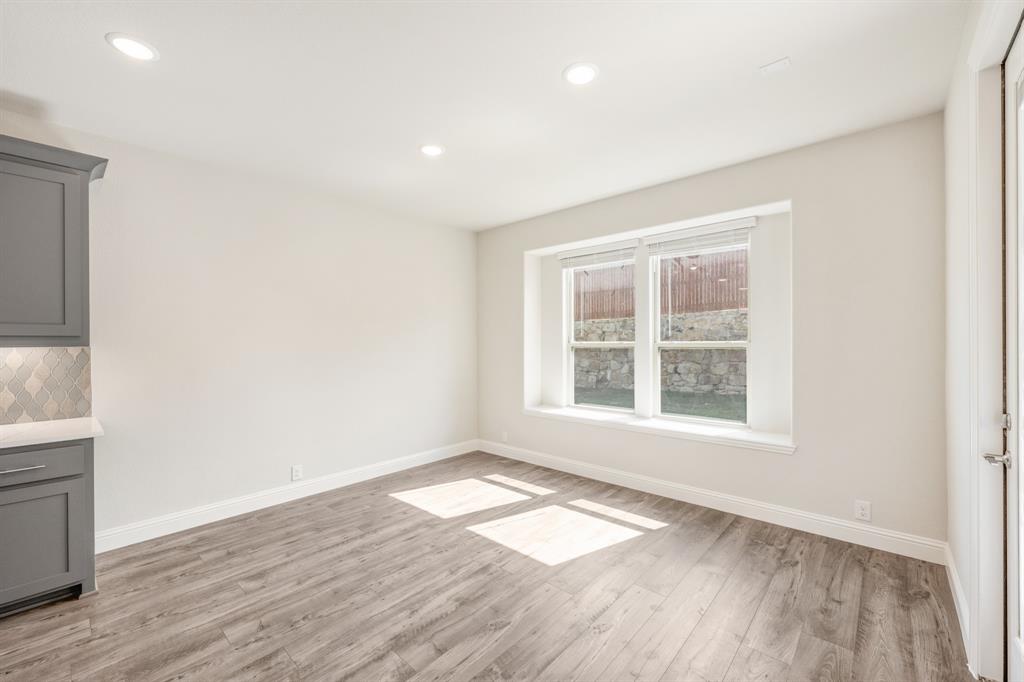 4410 Biscayne Drive Midlothian, TX 76065 - Photo 16 of 40 an empty room with wooden floor and windows
