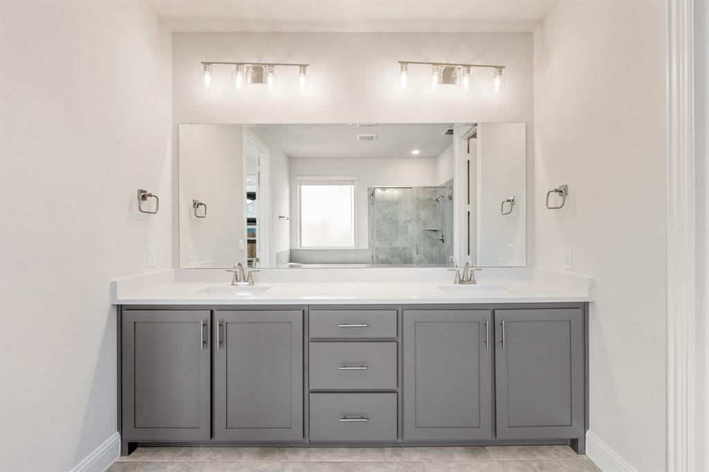 4410 Biscayne Drive Midlothian, TX 76065 - Photo 22 of 40 a bathroom with a double vanity sink and a mirror
