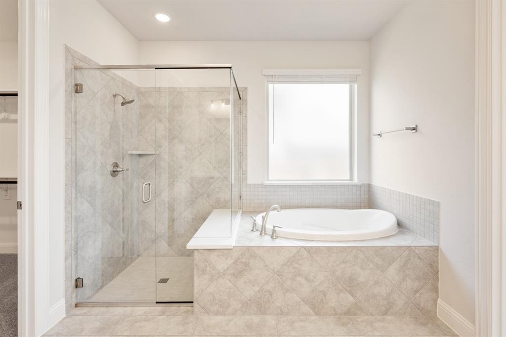 4410 Biscayne Drive Midlothian, TX 76065 - Photo 23 of 40 a bathroom with a tub a window and a shower