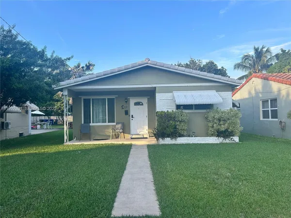 a front view of a house with a yard and porch