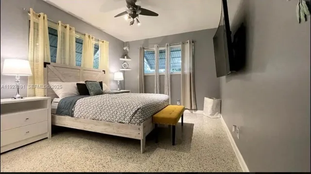 a bedroom with a bed couch and a window