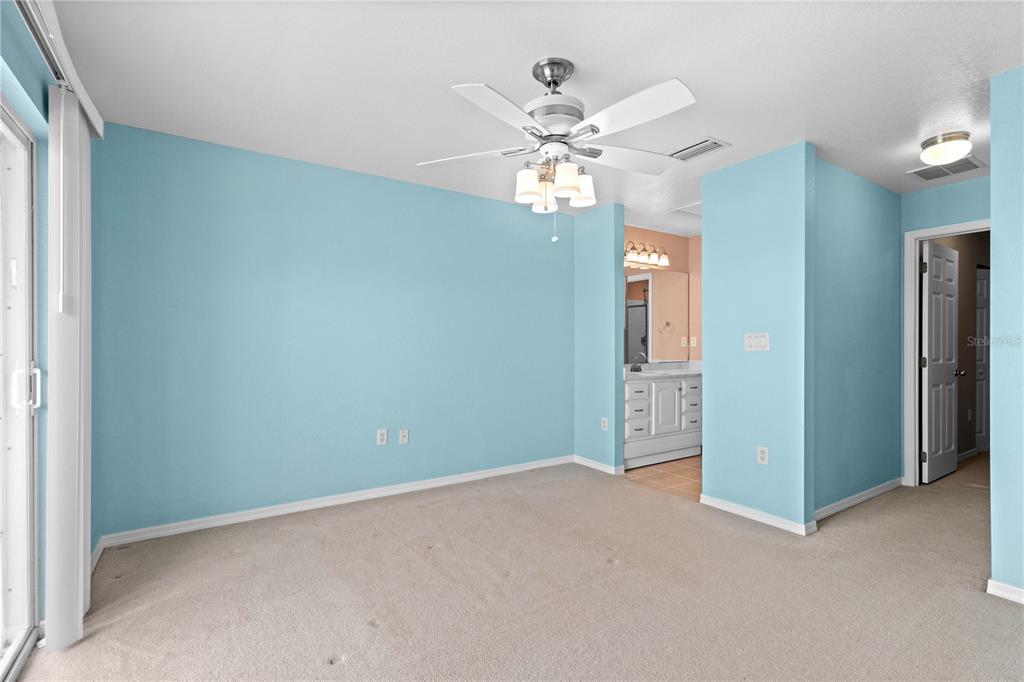 26346 Rampart Boulevard, Unit 904 Punta Gorda, FL 33983 - Photo 13 of 35 an empty room with chandelier fan