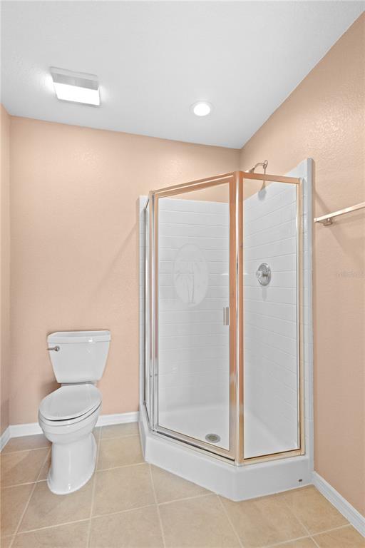 26346 Rampart Boulevard, Unit 904 Punta Gorda, FL 33983 - Photo 15 of 35 a bathroom with a toilet and shower