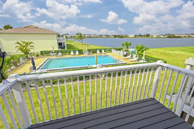 a view of a balcony with wooden floor and city view
