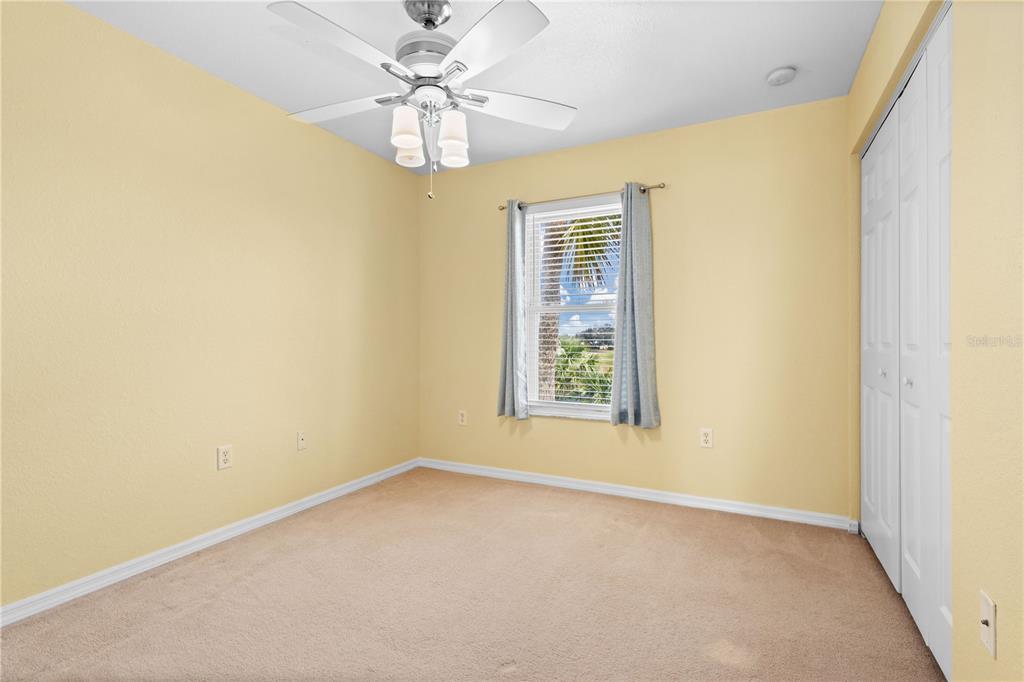 26346 Rampart Boulevard, Unit 904 Punta Gorda, FL 33983 - Photo 18 of 35 an empty room with windows and fan