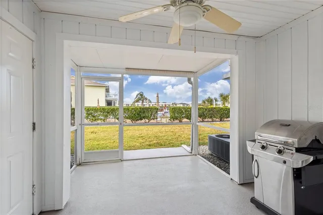 a kitchen with a stove a refrigerator and a view of living room