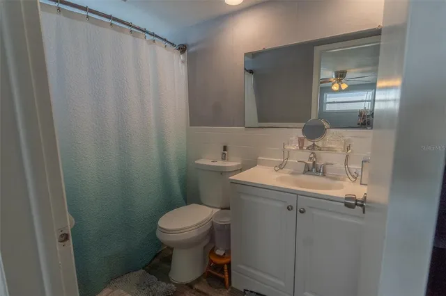 a bedroom with a bed a chair and a chandelier