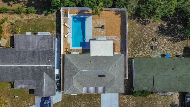 an aerial view of a house with swimming pool