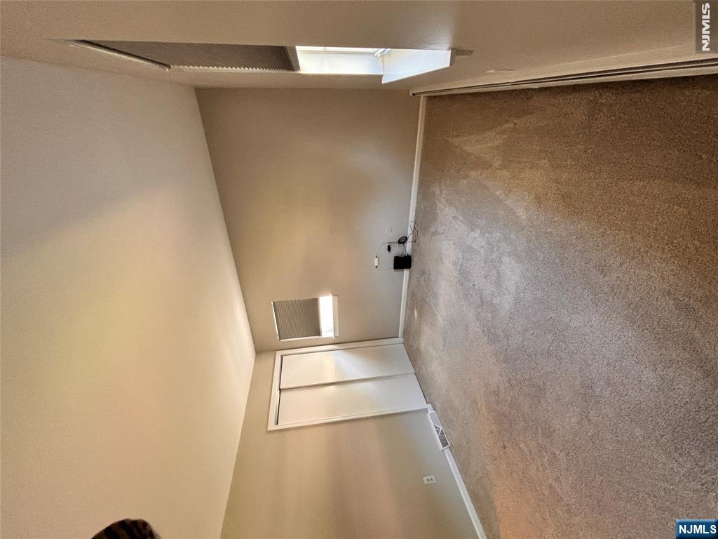 21 Wanamaker Avenue, Unit 1 Waldwick, NJ 07463 - Photo 7 of 13 an empty room with a empty space and windows