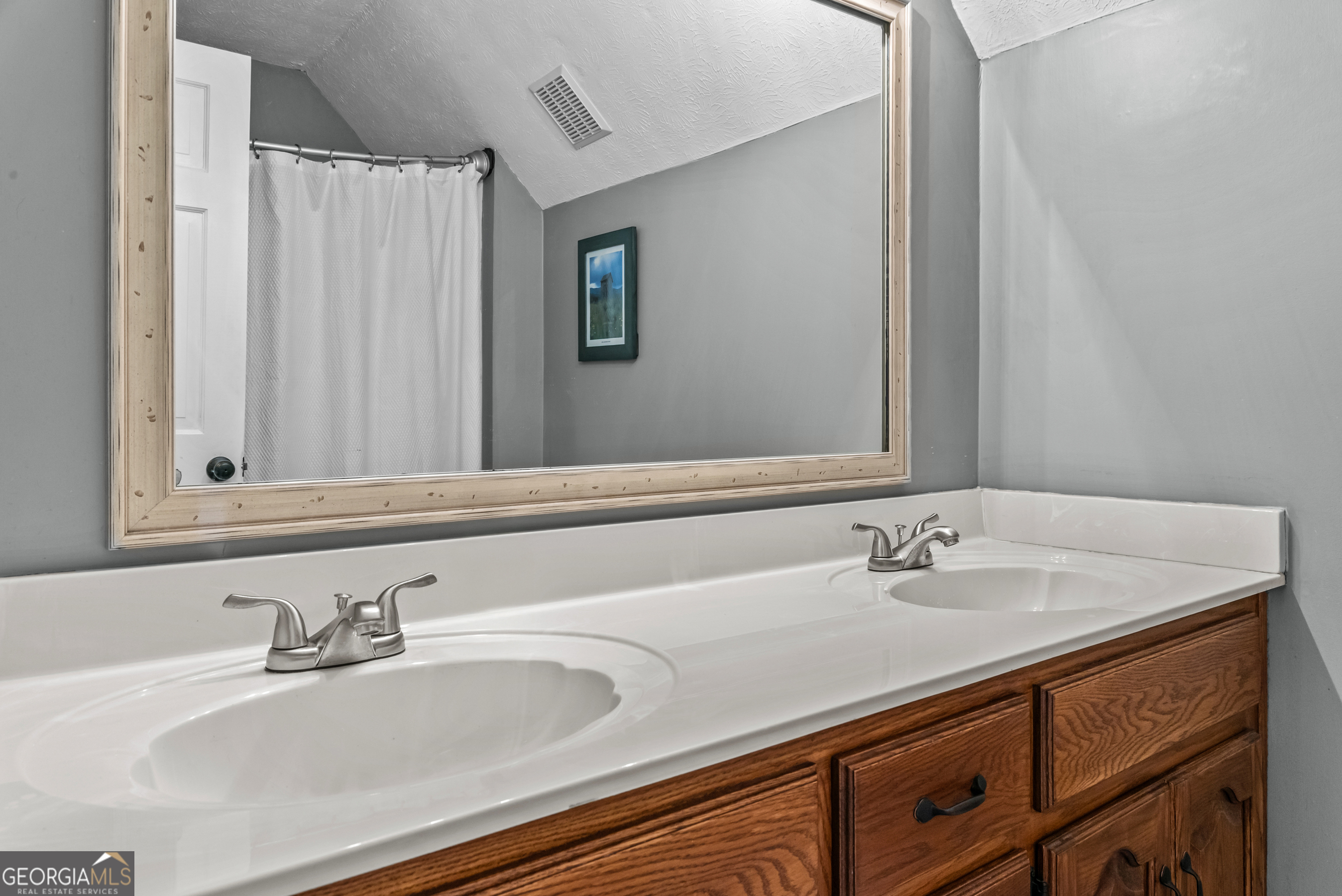 991 Crawford Street Madison, GA 30650 - Photo 14 of 25 a bathroom with a sink and a mirror