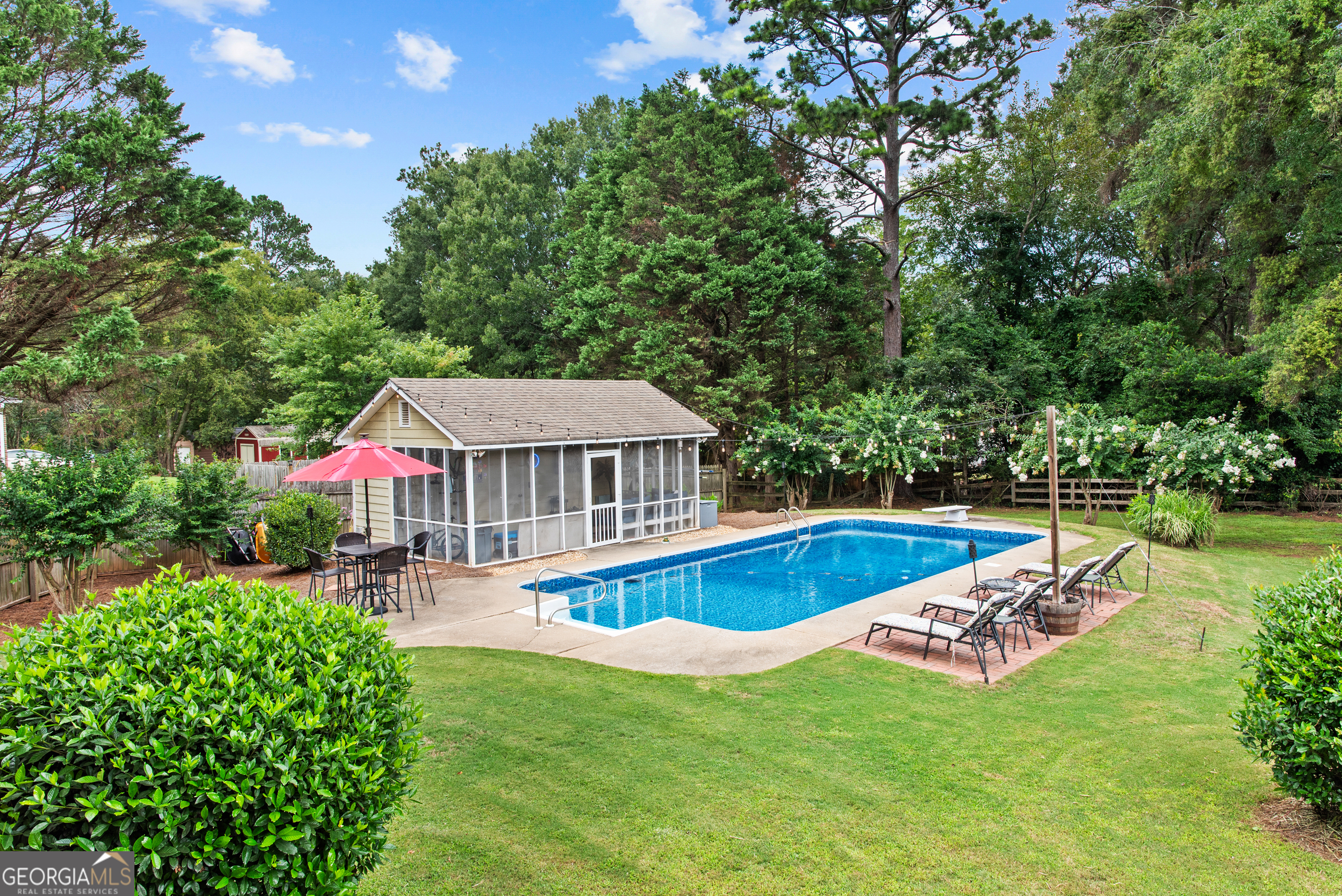 991 Crawford Street Madison, GA 30650 - Photo 17 of 25 a view of a house with swimming pool and yard