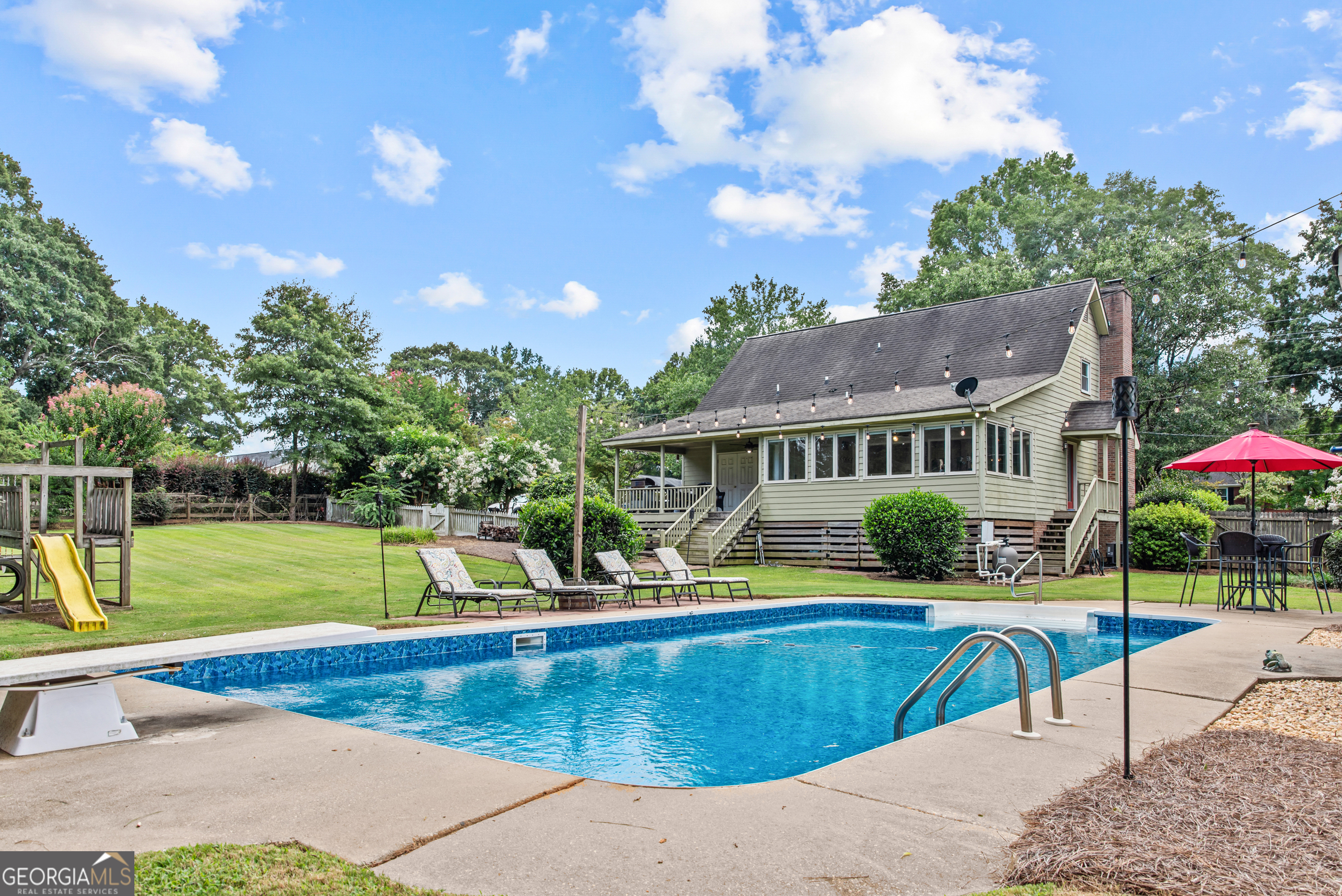 991 Crawford Street Madison, GA 30650 - Photo 18 of 25 a view of a house with a swimming pool