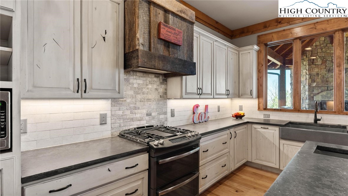 137 Burningbush Trail Boone, NC 28607 - Photo 13 of 50 a kitchen with stainless steel appliances a sink dishwasher a stove and white cabinets