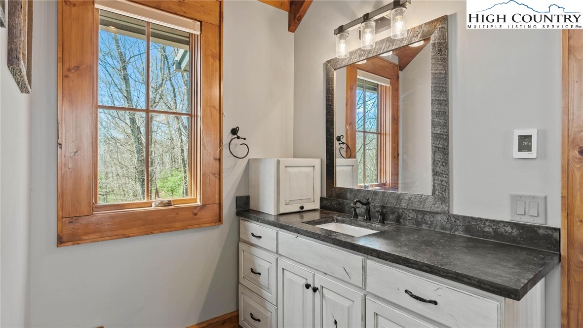 137 Burningbush Trail Boone, NC 28607 - Photo 21 of 50 a bathroom with a granite countertop sink and a mirror