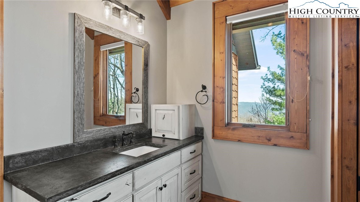 137 Burningbush Trail Boone, NC 28607 - Photo 22 of 50 a bathroom with a granite countertop sink and a mirror