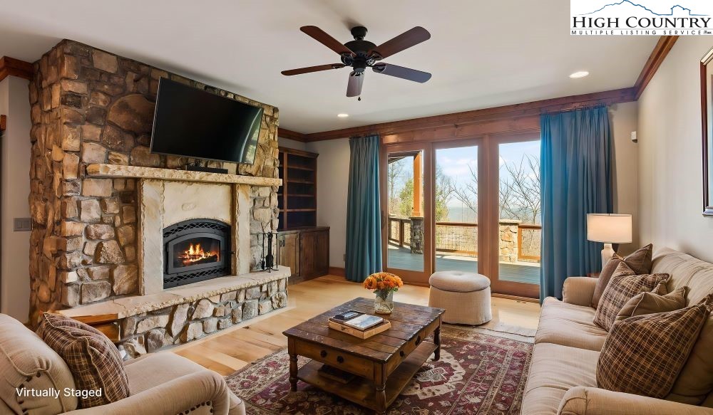 137 Burningbush Trail Boone, NC 28607 - Photo 26 of 50 a living room with furniture a fireplace and a flat screen tv