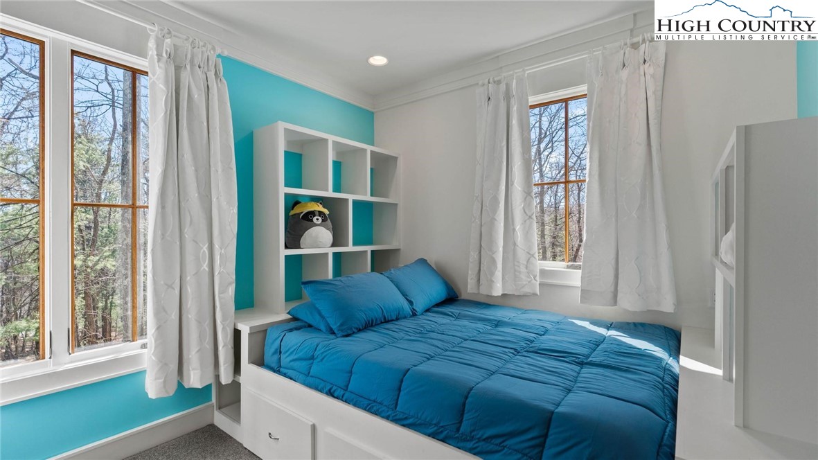 137 Burningbush Trail Boone, NC 28607 - Photo 32 of 50 a bedroom with a bed and a window with chair
