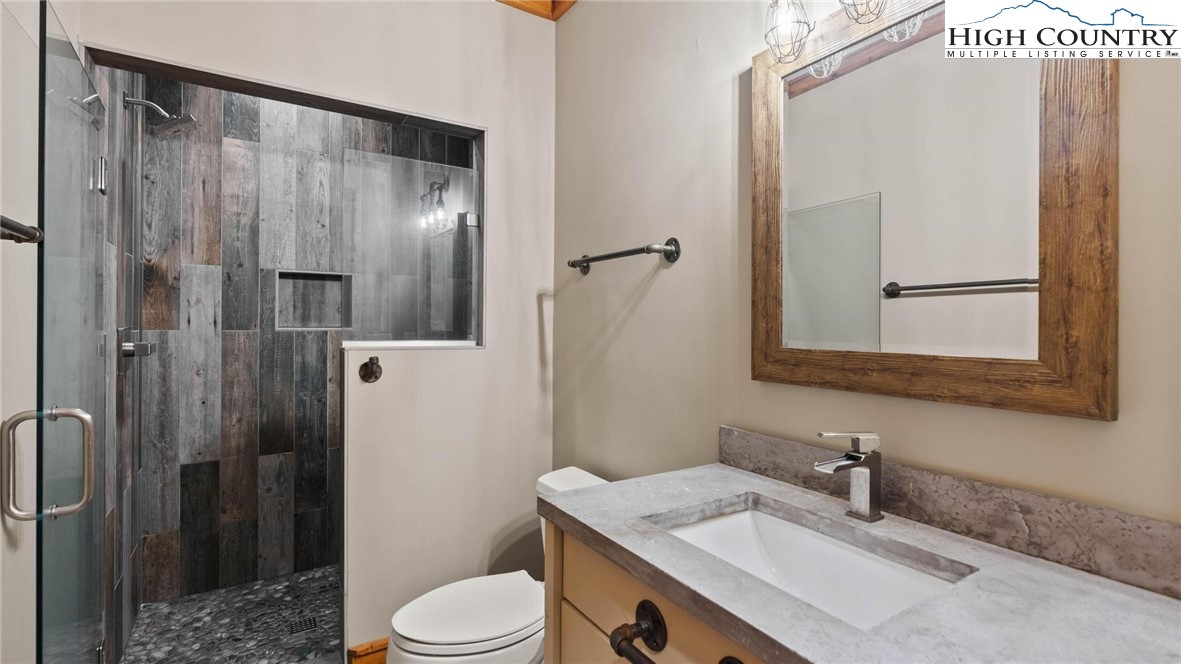 137 Burningbush Trail Boone, NC 28607 - Photo 36 of 50 a bathroom with a granite countertop sink toilet and shower