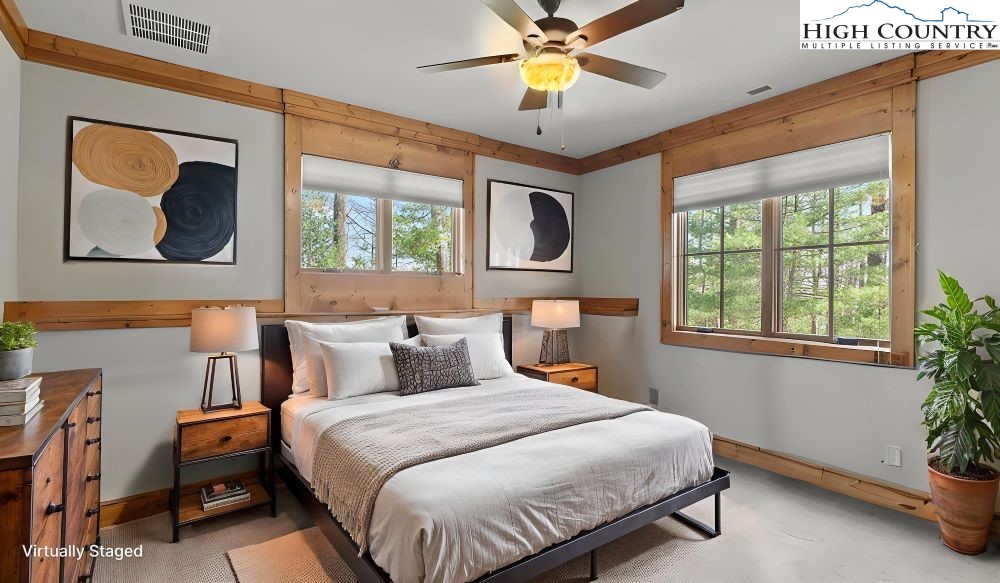 137 Burningbush Trail Boone, NC 28607 - Photo 40 of 50 a bedroom with a bed and a chandelier