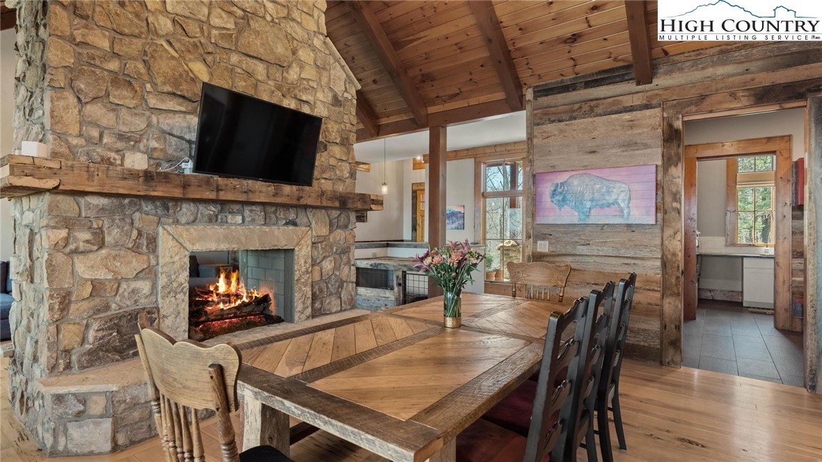 137 Burningbush Trail Boone, NC 28607 - Photo 9 of 50 a view of a dining room with furniture wooden floor and a fireplace