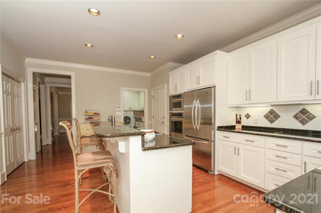 2125 South Wendover Road Charlotte, NC 28211 - Photo 18 of 48 a kitchen with stainless steel appliances kitchen island granite countertop a refrigerator and cabinets