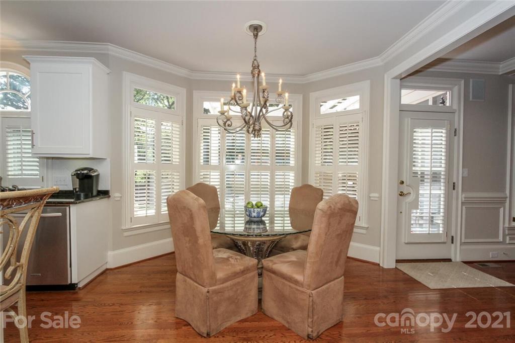 2125 South Wendover Road Charlotte, NC 28211 - Photo 19 of 48 a dining room with furniture a chandelier and wooden floor